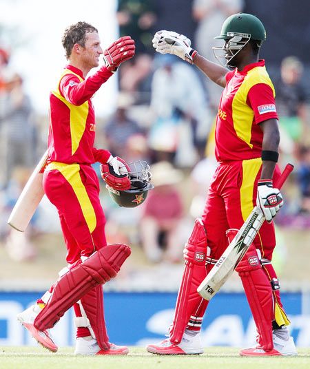 Zimbabwe's Sean Williams (left) and captain Elton Chigumbura celebrate after winning the 2015 ICC Cricket World Cup match against United Arab Emirates at Saxton Field in Nelson, New Zealand, on Thursday