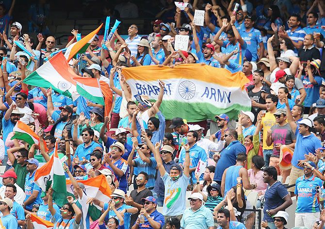 Indian fans in the crowd cheer and shout slogans on Sunday