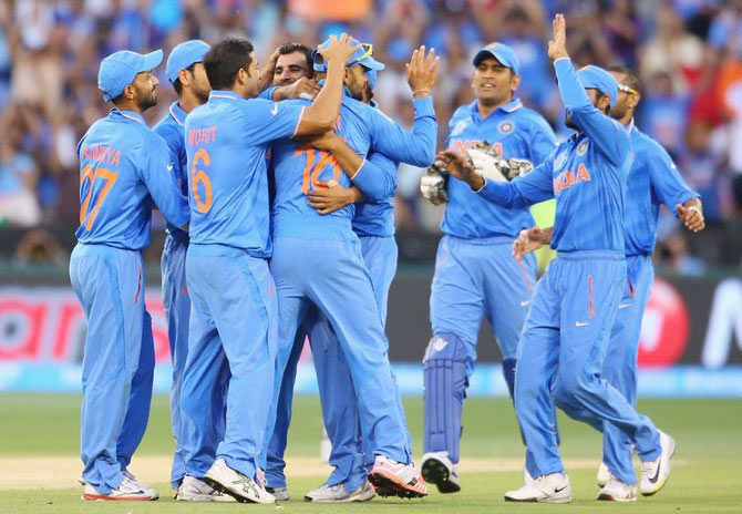 The Indian team celebrates the fall of a South African wicket in Melbourne 