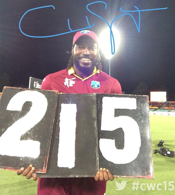 Chris Gayle signs an autograph for the camera after his record-breaking double century at the Manuka Ovel on Tuesday