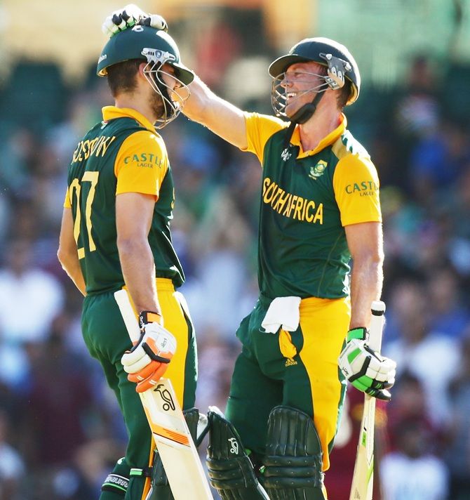 Rilee Rossouw, left, of South Africa celebrates with AB de Villiers after scoring a half century