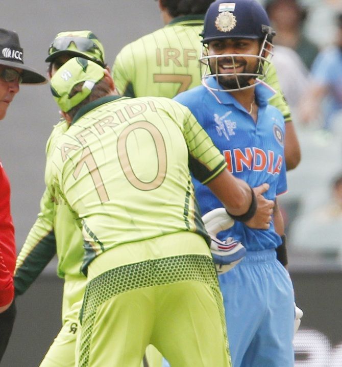Pakistan bowler Shahid Afridi rubs the back of India's Virat Kohli