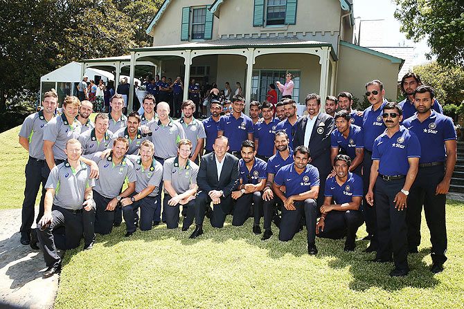Australian Prime Minister, Tony Abbott poses for a photo with the Indian and Australian Test Cricket teams during their visit at Kirribilli House in Sydney on Thursday