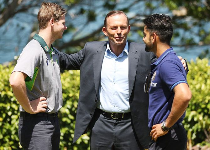  Australian Prime Minister Tony Abbott speaks with Australian captain Steve Smith, and Indian captain, Virat Kohli during the teams' visit to Kirribilli House in Sydney on Thursday