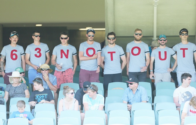 Spectators in the crowd wear shirts that spell 63 Not Out in memory of Phillip Hughes