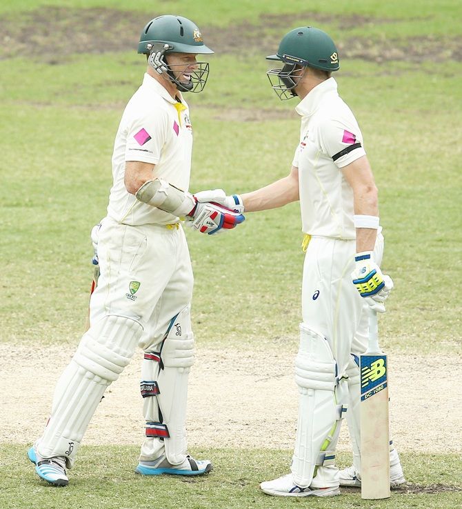Chris Rogers of Australia is congratulated by captain Steve Smith after scoring fifty runs