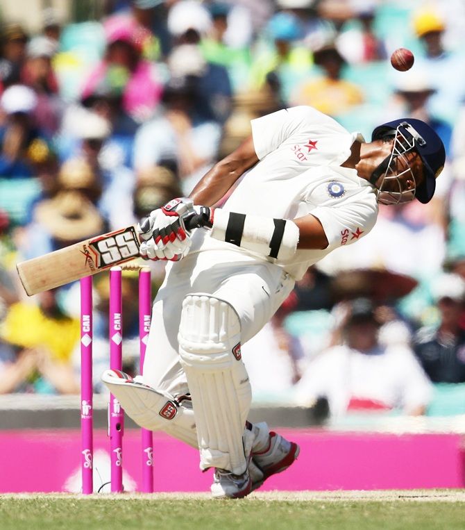 Wriddhiman Saha of India ducks under a high delivery from Mitchell Starc of Australia