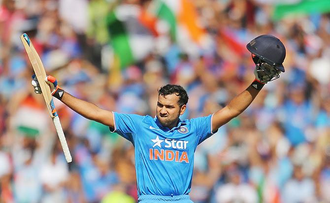 India's Rohit Sharma celebrates as he reaches his century during the 2nd One-Day International against Australia during their tri-series at the Melbourne Cricket Ground  on Sunday