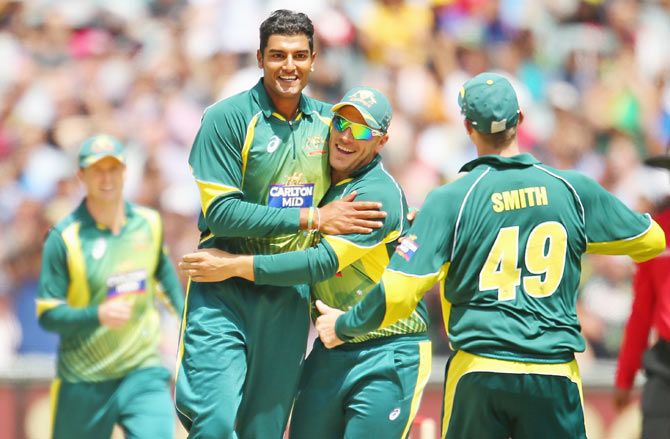 Gurinder Sandhu of Australia celebrates with his teammates after dismissing Ajinkya Rahane of India