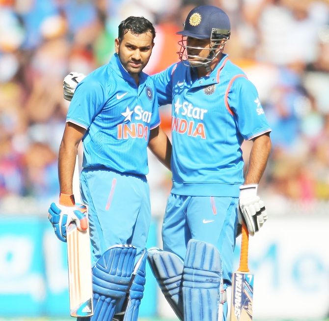 Rohit Sharma of India celebrates as he reaches his century with Mahendra Singh Dhoni