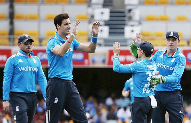 England's bowler Steven Finn (2nd from left) celebrates the dismissal of India's Ajinkya Rahane, after the latter was caught by England's James Taylor (2nd from right), during their One-Day International tri-series in Brisbane on Tuesday