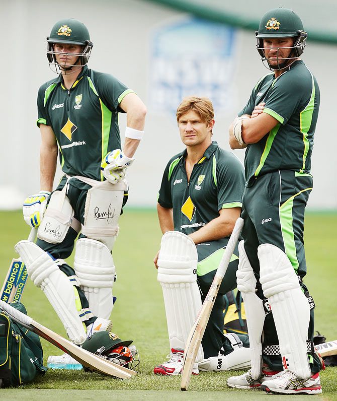 Steve Smith, Shane Watson and Ryan Harris wait to bat during an Australian nets session 