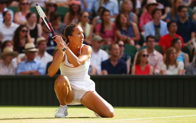 Serbia's Jelena Jankovic plays a backhand shot in her third round match against Czech Republic's Petra Kvitova during at the Wimbledon Championships on Saturday