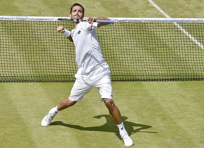 Serbia's Viktor Troicki celebrates after beating Germany's Dustin Brown in their third round match at the Wimbledon Tennis Championships in London on Saturday