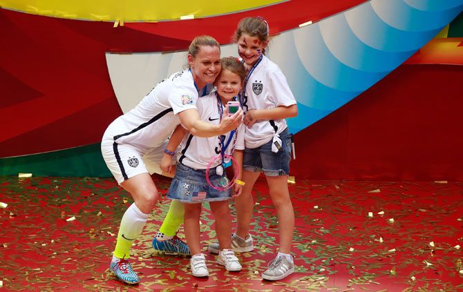 Christie Rampone of the United States celebrates with daughters Rylie and Reece