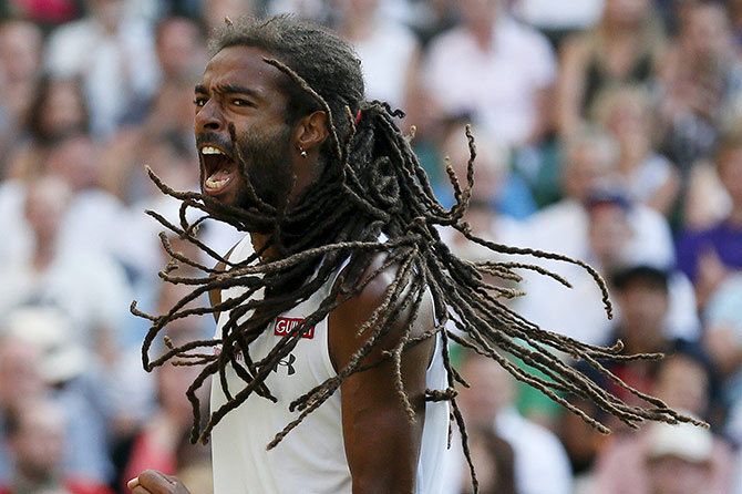Germany's Dustin Brown celebrates a point during his match against Rafael Nadal of Spain at the Wimbledon. Brown upset Nadal 7-5, 3-6, 6-4, 6-4 to reach the third round of the Champoionship but eventually lost to Serbian Viktor Troicki