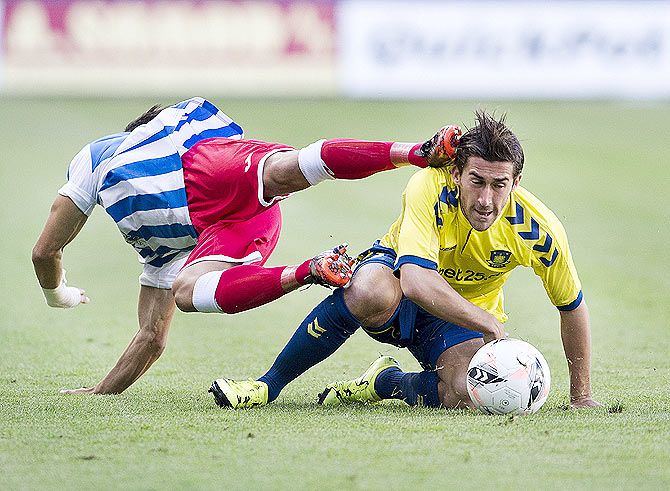 Brondby's Frederik Holst (right) is challenged by a Juvenes/Dogana player during their Europa League soccer match at Brondby Stadium in Copenhagen on July 2