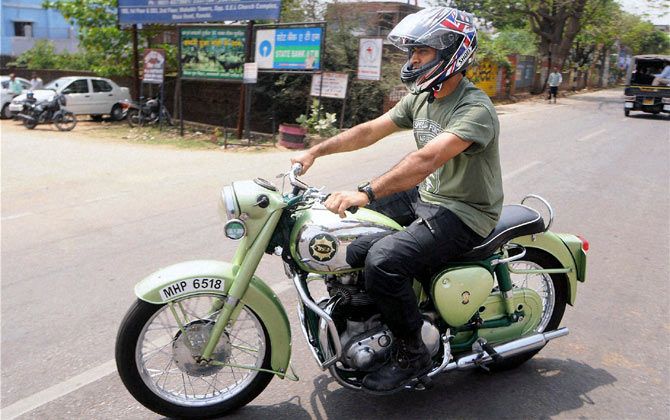 Mahendra Singh Dhoni rides on of his many bikes in Ranchi