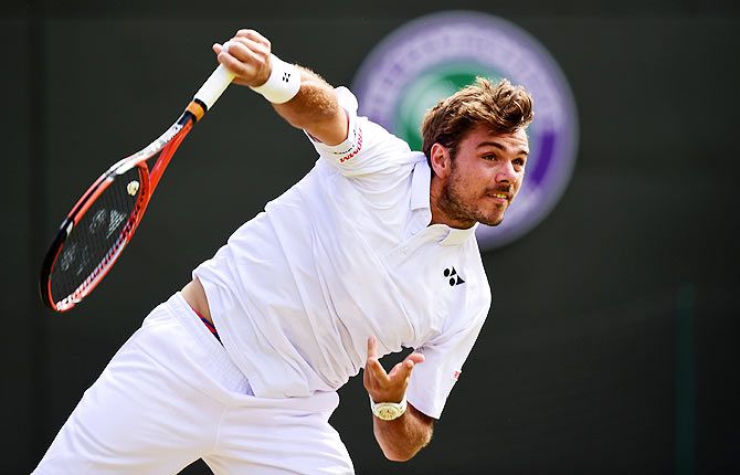 Switzerland's Stanislas Wawrinka serves in his fourth round match against Belgium's David Goffin during the Wimbledon Championships at the All England Lawn Tennis and Croquet Club in London on Monday