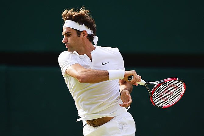 Switzerland's Roger Federer slaps a forehand in his Wimbledon semi-final match against Great Britain's Andy Murray on Friday