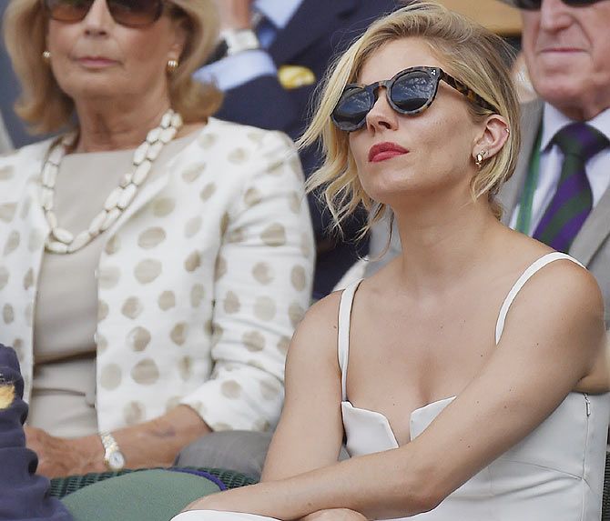 Hollywood actor Sienna Miller on Centre Court watches the Wimbledon semi-final in London on Friday