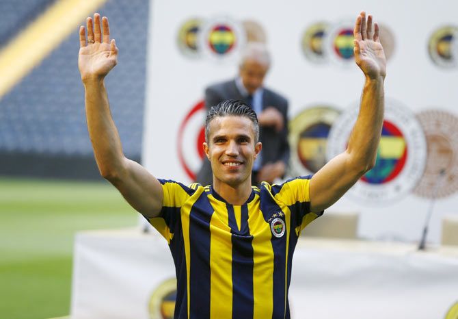 Netherlands striker Robin van Persie greets supporters during his contract-signing ceremony with Turkish club Fenerbahce at Sukru Saracoglu Stadium in Istanbul, Turkey, on Tuesday
