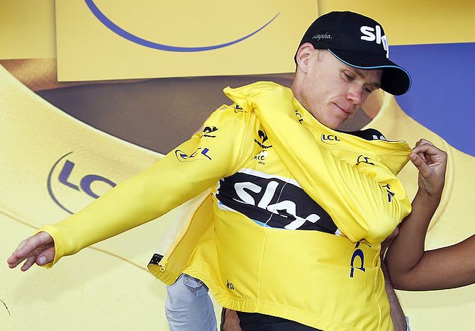 Team Sky rider Chris Froome of Britain wears the race leader's yellow jersey on the podium after the 188-km (116.8 miles) 11th stage of the 102nd Tour de France cycling race from Pau to Cauterets in the French Pyrenees mountains, France on Wednesday