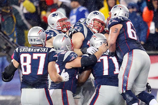 Nate Solder #77 of the New England Patriots celebrates a touchdown with teammates in the second half against the Indianapolis Colts of the 2015 AFC Championship Game