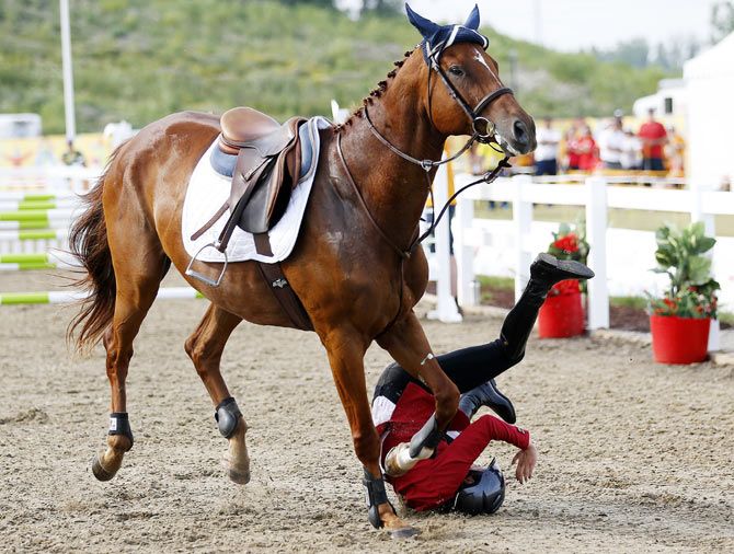 Dashalia Mendoza of Ecuador falls off her horse in the modern pentathlon during the 2015 Pan Am Games at Pan Am Aquatics UTS Centre and Field House in Toronto, Ontario on Saturday, July 18. Photograph: Jeff Swinger-USA TODAY Sports/Reuters