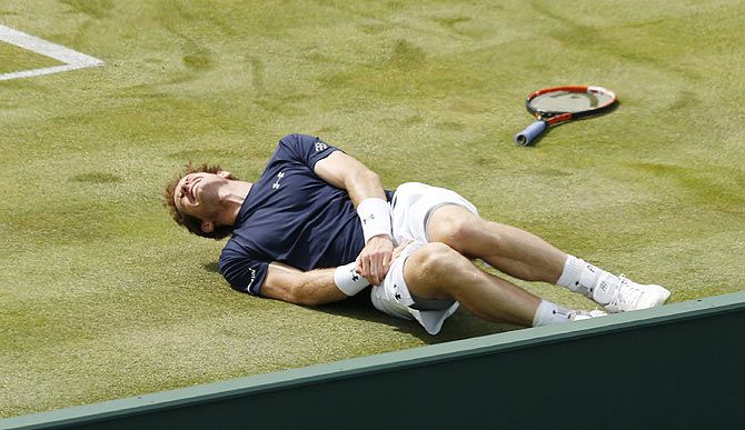 Britain's Andy Murray slips during his Davis Cup doubles match