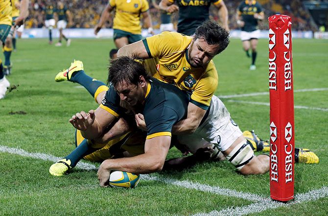 South Africa's Springboks Lock Eben Etzebeth scores a try as Australia's Wallabies Adam Ashley-Cooper attempts to tackle him during their Rugby Championship match in Brisbane, on Saturday, July 18
