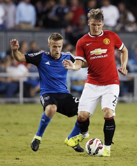 Manchester United's Bastian Schweinsteiger (right) dribbles past San Jose Earthquakes' Tommy Thompson during the second half of their International Champions Cup match at Avaya Stadium in San Jose, California, on Tuesday