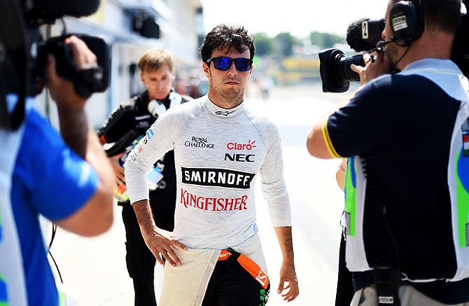 Force India's Sergio Perez of Mexico returns to the pit lane after crashing during practice at the Hungarian Formula One Grand Prix at Hungaroring in Budapest on Friday