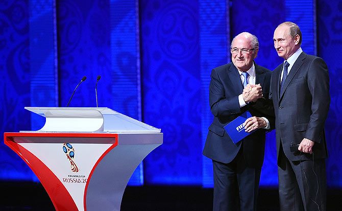 FIFA President Joseph S Blatter shakes hands with Vladimir Putin, President of Russia during the Preliminary Draw of the 2018 FIFA World Cup in Russia at The Konstantin Palace in Saint Petersburg, Russia, on Saturday