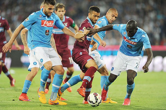 Lazio's Felipe Anderson vies with SSC Napoli's David Lopez and Kalidou Koulibaly