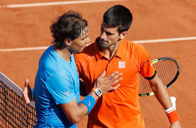 Novak Djokovic shakes hands with Rafael Nadal after winning their French quarter-final
