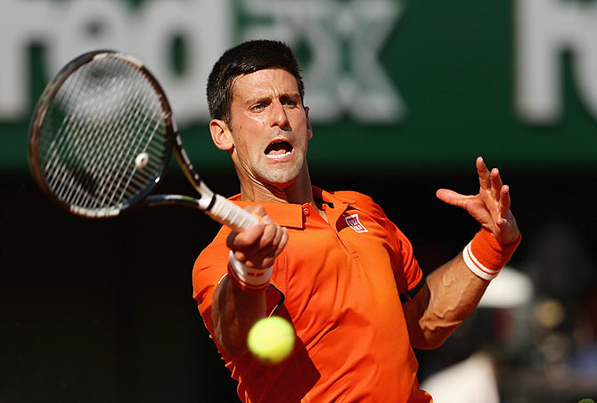 Novak Djokovic plays a return against Andy Murray on Friday