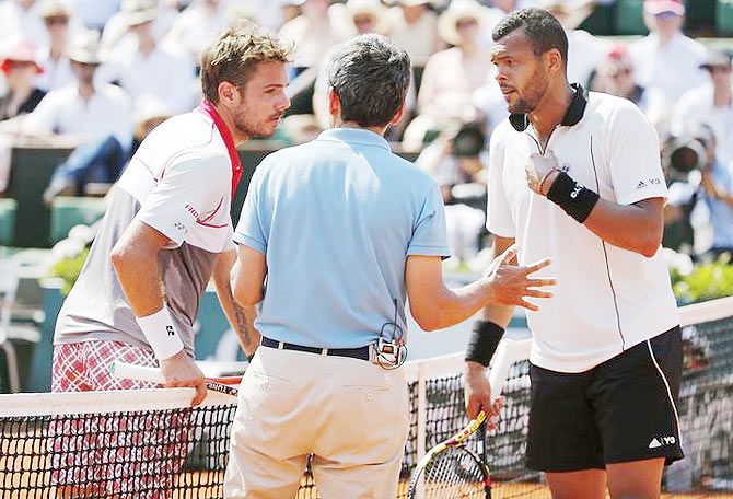 Jo-Wilfried Tsonga (right) and Stan Wawrinka Switzerland (left) argue with a referee during their men's semi-final on Saturday