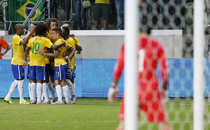 Brazil's players celebrate Diego Tardelli's (2nd from right) goal against Mexico during a friendly match in Sao Paulo, on Sunday