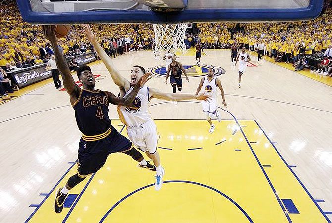 Cleveland Cavaliers guard Iman Shumpert (4) shoots the ball against Golden State Warriors guard Klay Thompson (11) in game two of the NBA Finals at Oracle Arena in Oakland, California