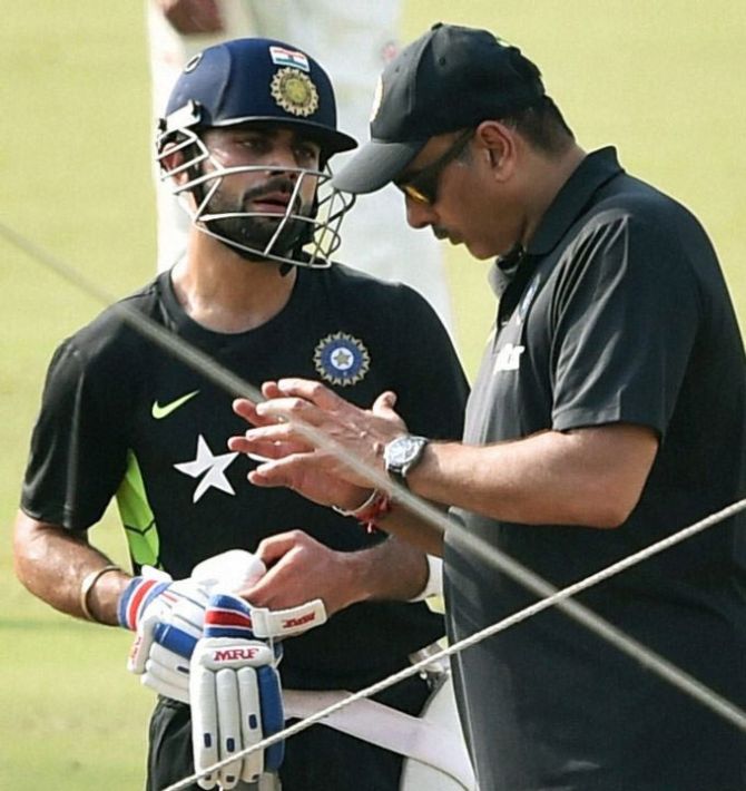 Indian captaIn Virat Kohli speaks with Team Director Ravi Shastri