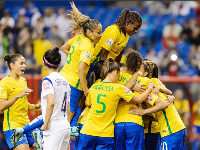 Marta #10 of Brazil celebrates a goal on a penalty kick with teammates during their 2015 FIFA Women's World Cup Group E match against Korea Republic at Olympic Stadium in Montreal, Quebec, Canada, on Tuesday
