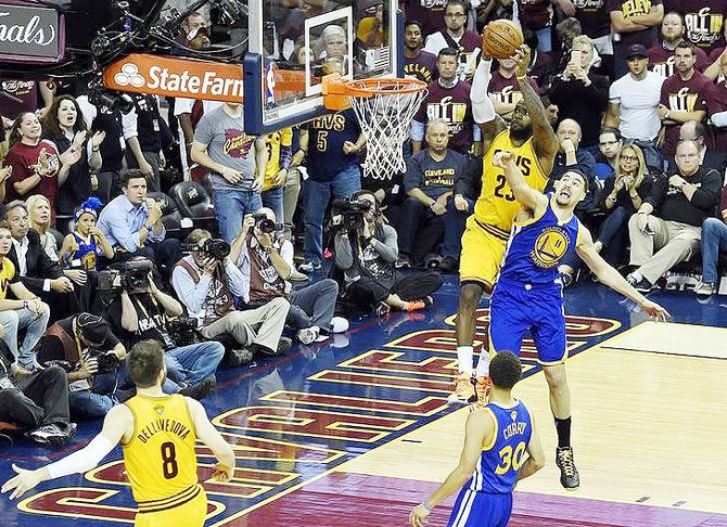 Cleveland Cavaliers forward LeBron James (23) dunks the ball over Golden State Warriors guard Klay Thompson (11) in game three of the NBA Finals at Quicken Loans Arena in Cleveland, Ohio on Tuesday