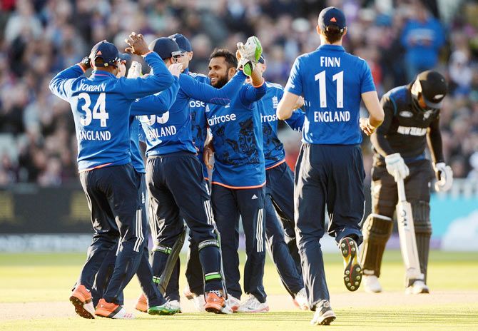 England's Adil Rashid celebrates with teammates after dismissing New Zealand's Luke Ronchi