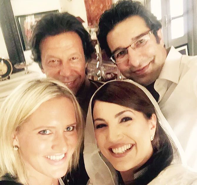 Imran Khan and Wasim Akram pose with their wives.