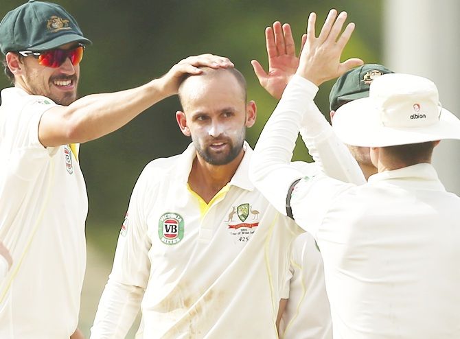 Australia's Nathan Lyon, centre, celebrates after taking a wicket