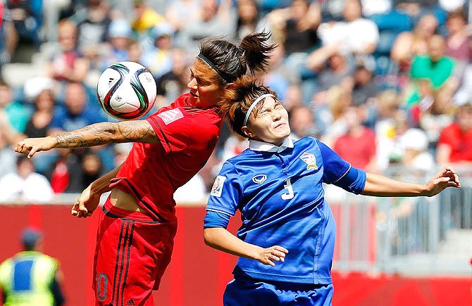 Thailand's Natthakarn Chinwong (right) challenges Germany's Dzsenifer Marozsan for an aerial ball during their FIFA Women's World Cup 2015 match at Winnipeg Stadium in Canada on Monday