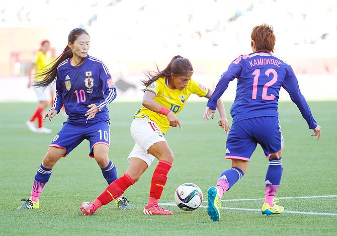 Kerlly Real #19 of Ecuador controls the ball against Homare Sawa #10 and Megumi Kamionobe #12 of Japan