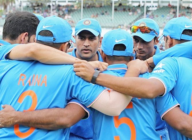 The Indian team huddles.