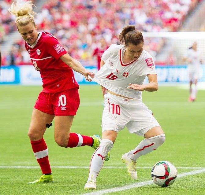 Switzerland's Ramona Bachmann (right) is challenged by Canada's Lauren Sesselmann during their FIFA Women's World Cup match in Canada on June 22